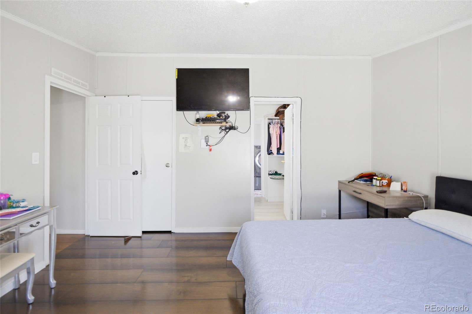 1724 Clark Street Aurora, CO 80011 - Photo 16 of 19 a bedroom with a bed and a flat screen tv