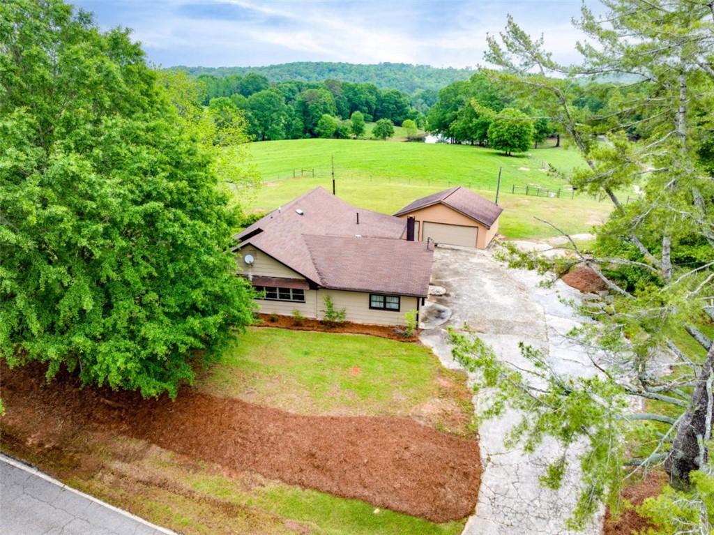 a aerial view of a house with swimming pool garden and patio
