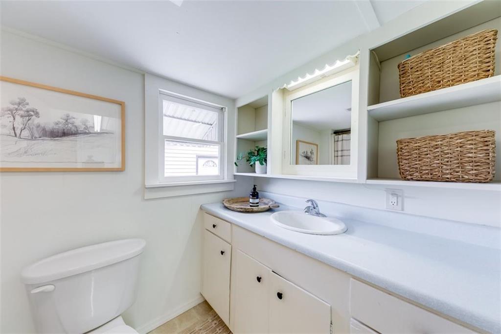 2630 Prospect Road Toccoa, GA 30577 - Photo 28 of 40 a bathroom with a granite countertop sink mirror and toilet