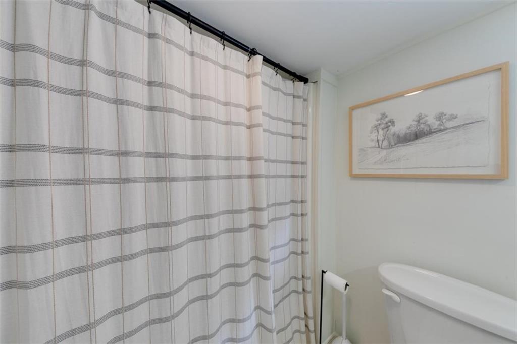 2630 Prospect Road Toccoa, GA 30577 - Photo 29 of 40 a bathroom with a toilet and a shower curtain