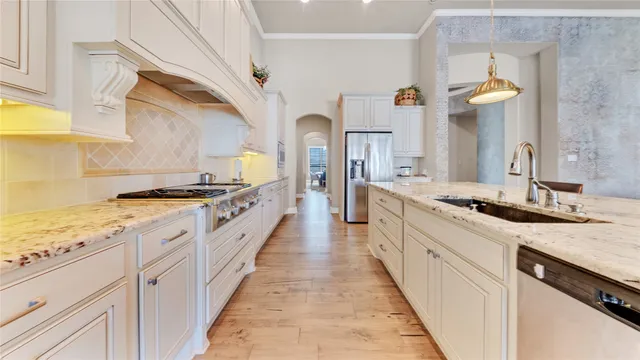 a large kitchen with a stove and a sink