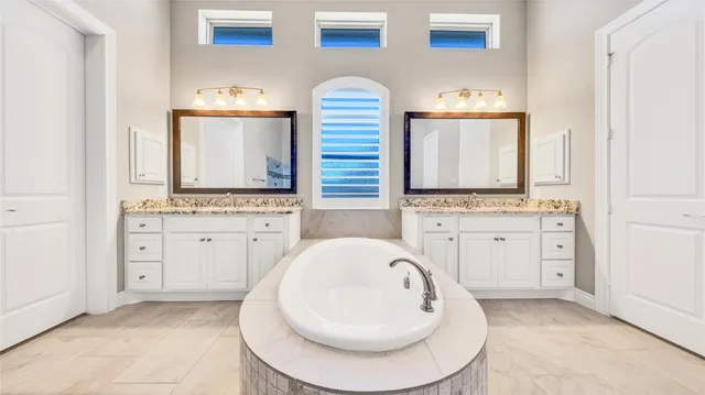 a bathroom with a granite countertop sink and mirror