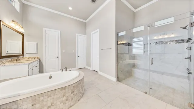 a bathroom with a granite countertop tub sink shower and mirror