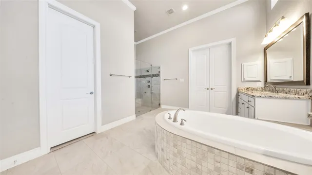 a spacious bathroom with a tub shower and mirror
