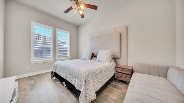 a living room with a bed furniture and a large window