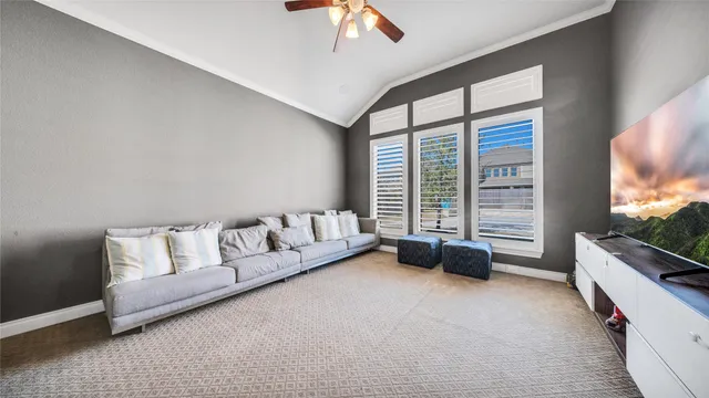 a bedroom with furniture and a large window