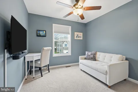 a view of a livingroom with furniture and a flat screen tv