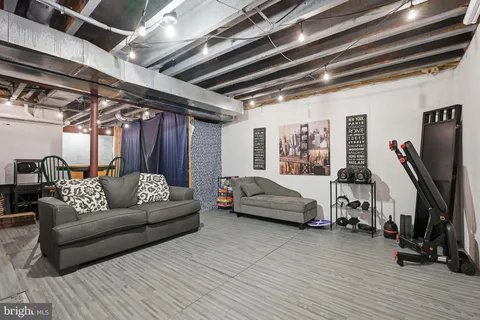 a dining room with furniture and wooden floor