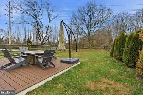 a view of a chairs and table on the wooden deck