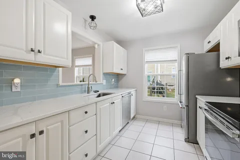 a kitchen with stainless steel appliances granite countertop a stove microwave and cabinets