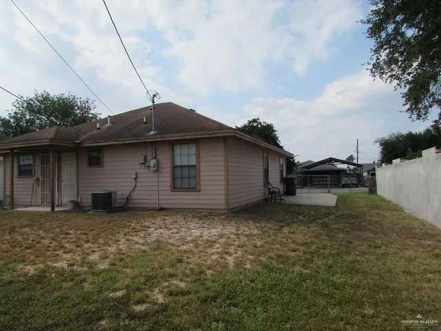 a backyard of a house with yard and barbeque oven