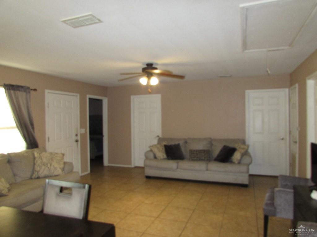 2936 Jasmine Street Roma, TX 78584 - Photo 6 of 12 a living room with furniture and a chandelier