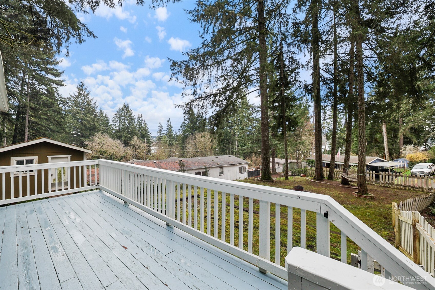 41 Barbara Lane Belfair, WA 98528 - Photo 7 of 28 a view of a wooden deck and trees with wooden fence