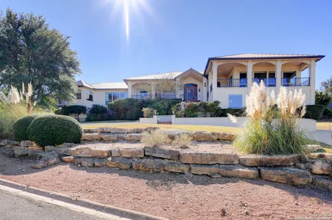 a view of a pathway of house with potted plants