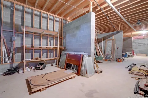 an aerial view of a house with garden space and a car park side of the road