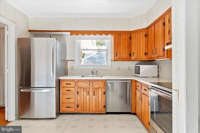 an empty room with a white cabinet and a window