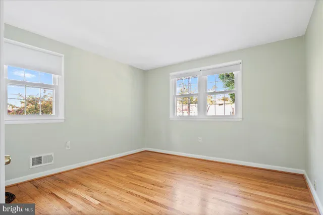 a view of a room with wooden floor and windows