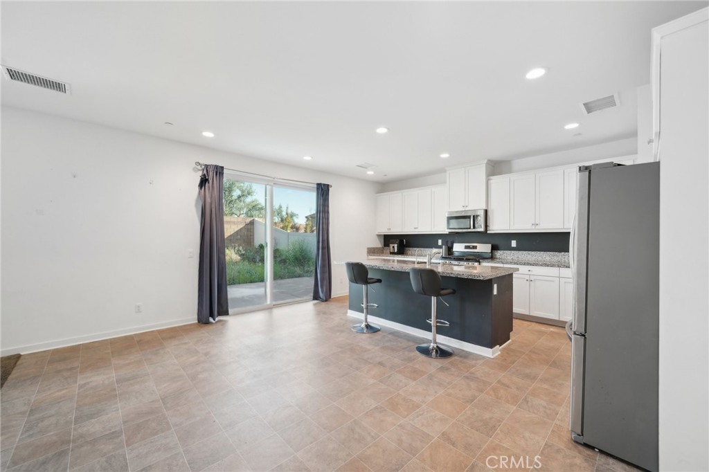 36927 Arezzo Court Beaumont, CA 92223 - Photo 14 of 53 a kitchen with a refrigerator and a sink