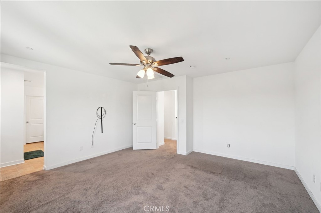 36927 Arezzo Court Beaumont, CA 92223 - Photo 18 of 53 a view of a livingroom with a ceiling fan and wooden floor