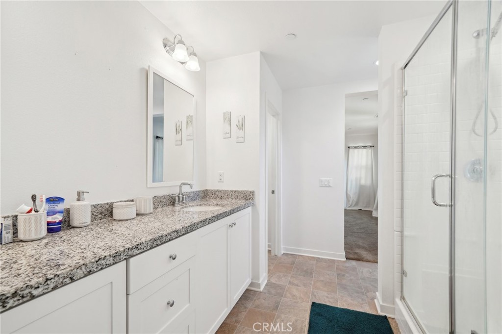 36927 Arezzo Court Beaumont, CA 92223 - Photo 21 of 53 a bathroom with a granite countertop sink and a mirror
