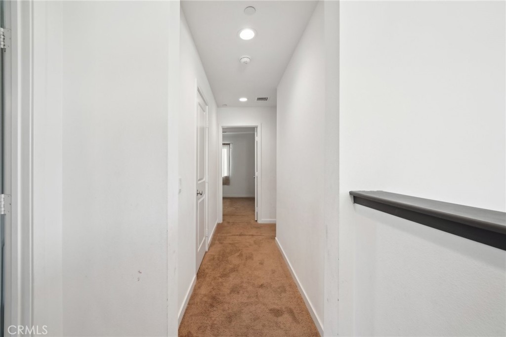 36927 Arezzo Court Beaumont, CA 92223 - Photo 24 of 53 a view of a hallway with wooden floor