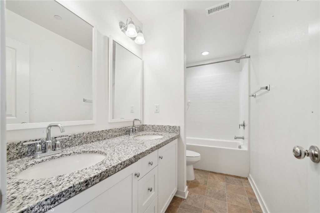 36927 Arezzo Court Beaumont, CA 92223 - Photo 28 of 53 a bathroom with a granite countertop sink and a mirror
