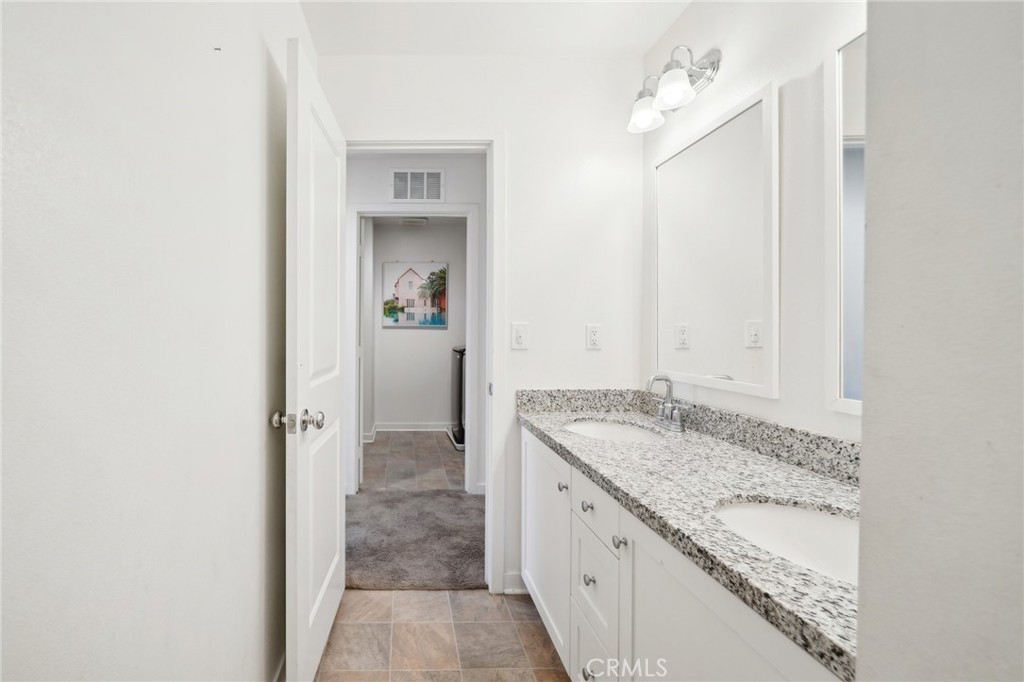 36927 Arezzo Court Beaumont, CA 92223 - Photo 29 of 53 a bathroom with a granite countertop sink and a mirror