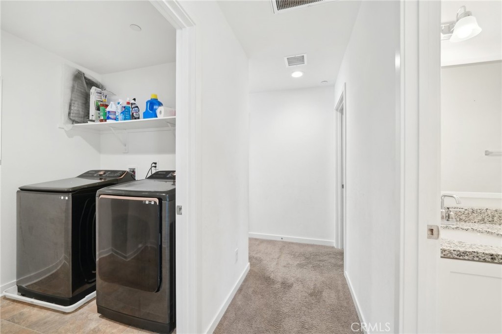 36927 Arezzo Court Beaumont, CA 92223 - Photo 30 of 53 a view of storage and utility room with washer and dryer