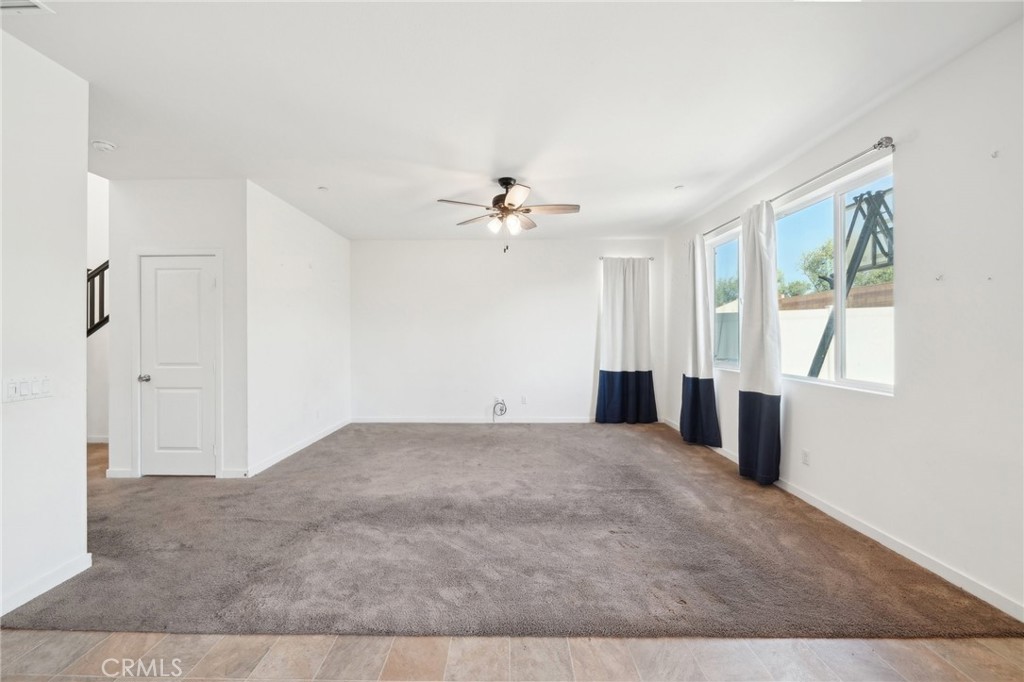 36927 Arezzo Court Beaumont, CA 92223 - Photo 8 of 53 a view of a livingroom with a ceiling fan and window