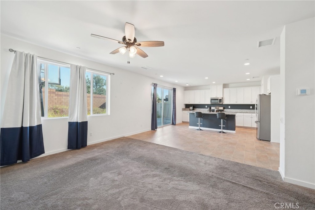 36927 Arezzo Court Beaumont, CA 92223 - Photo 9 of 53 a view of an empty room with kitchen view and a window