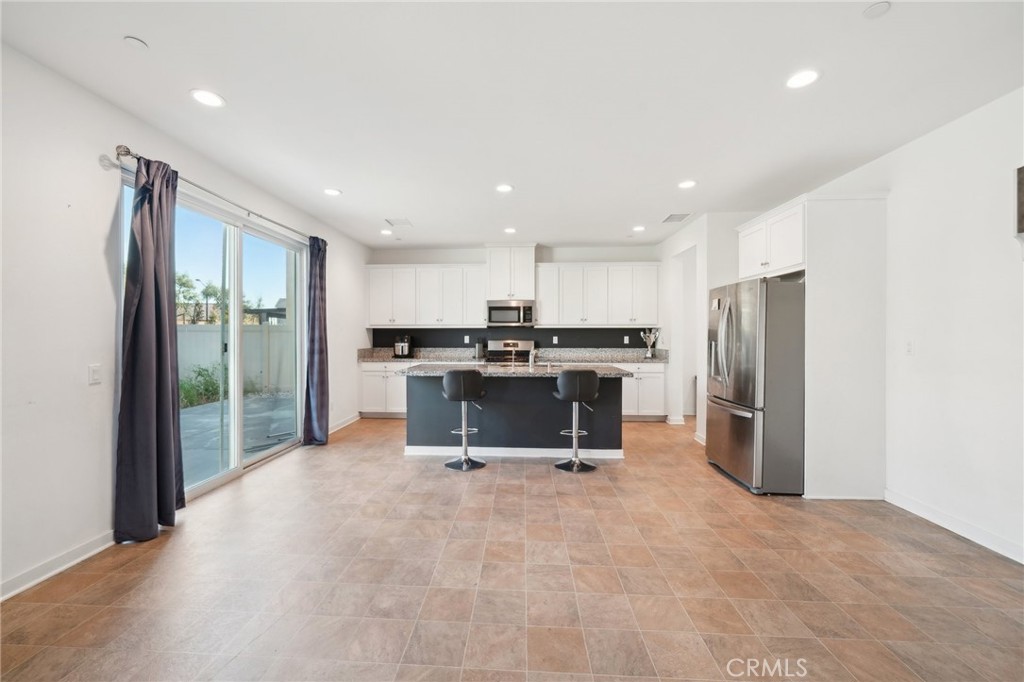 36927 Arezzo Court Beaumont, CA 92223 - Photo 10 of 53 a kitchen with stainless steel appliances a refrigerator and a stove top oven
