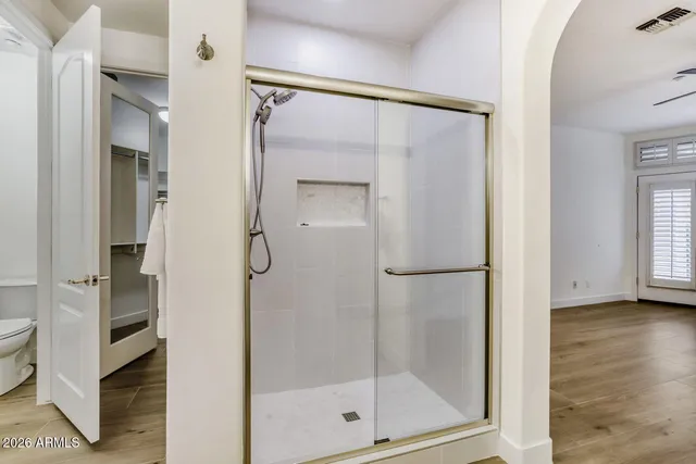 a bathroom with a glass shower door