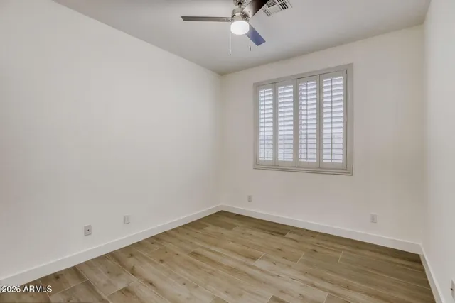 wooden floor in an empty room with a window
