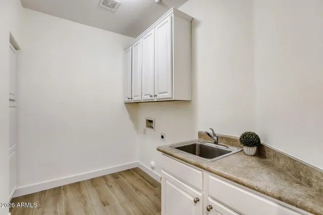 a kitchen with a sink and cabinets