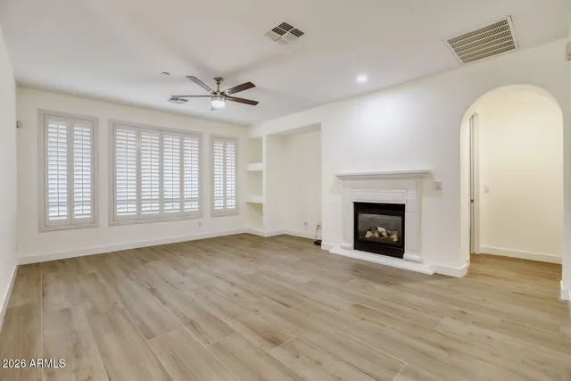 wooden floor fireplace and natural light in room