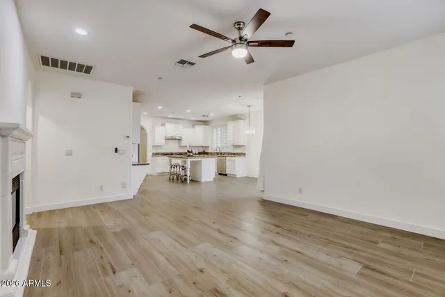 a view of empty room with wooden floor and window