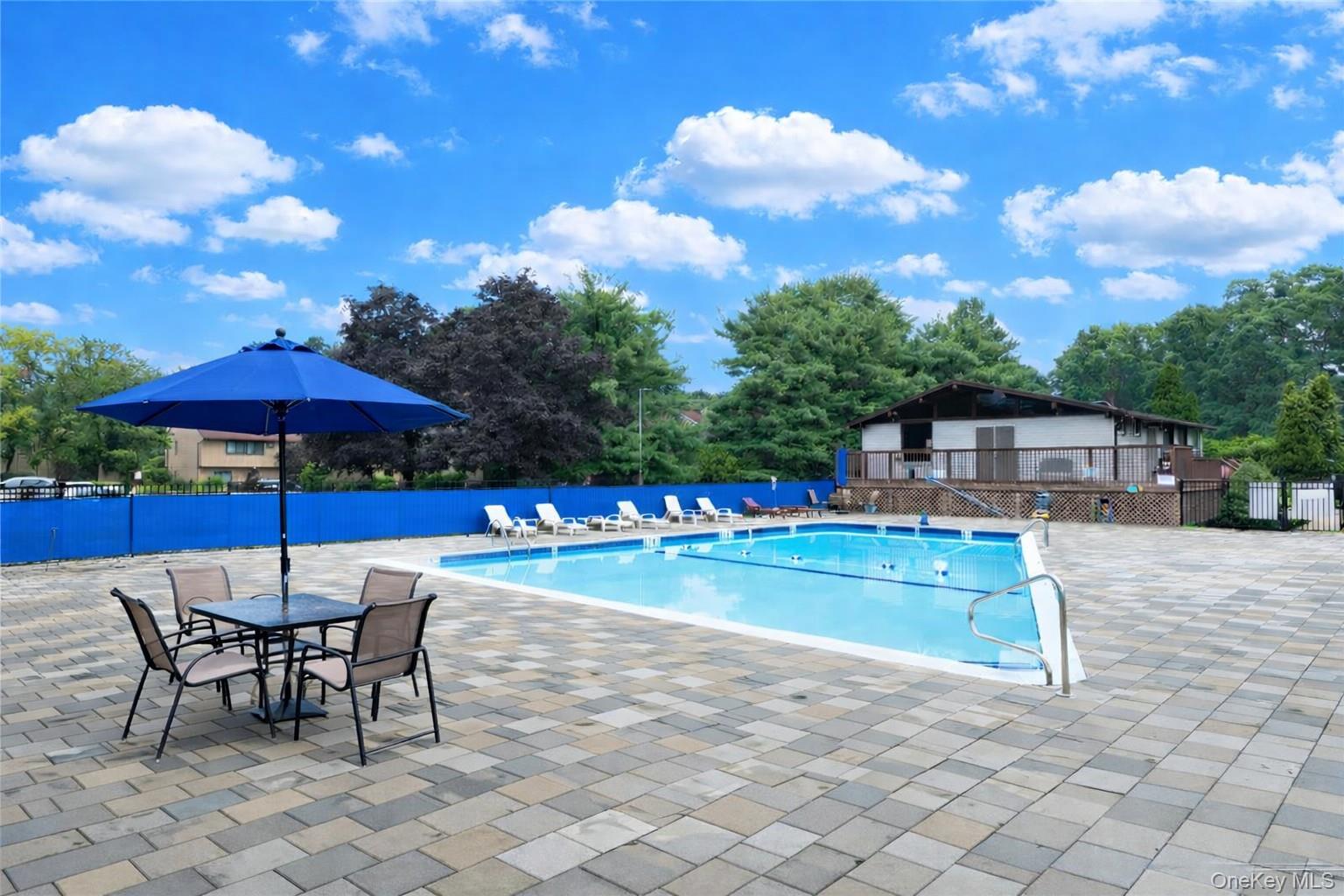 32 Hurlihe Street, Unit A Poughkeepsie, NY 12601 - Photo 20 of 21 a view of a swimming pool with a table and chairs under an umbrella