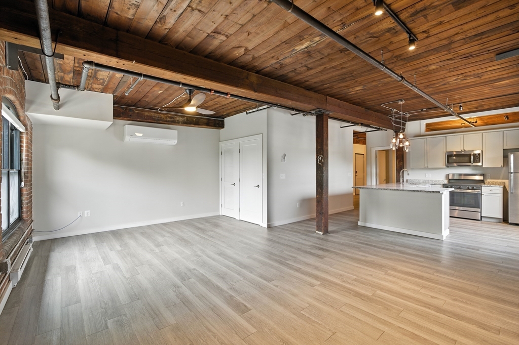 55 Sterling Street, Unit 212 Clinton, MA 01510 - Photo 24 of 35 a view of empty room with wooden floor