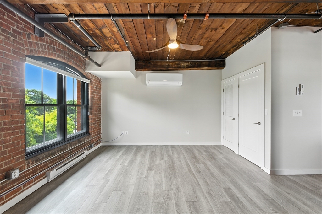 55 Sterling Street, Unit 212 Clinton, MA 01510 - Photo 25 of 35 a view of a room with wooden floor