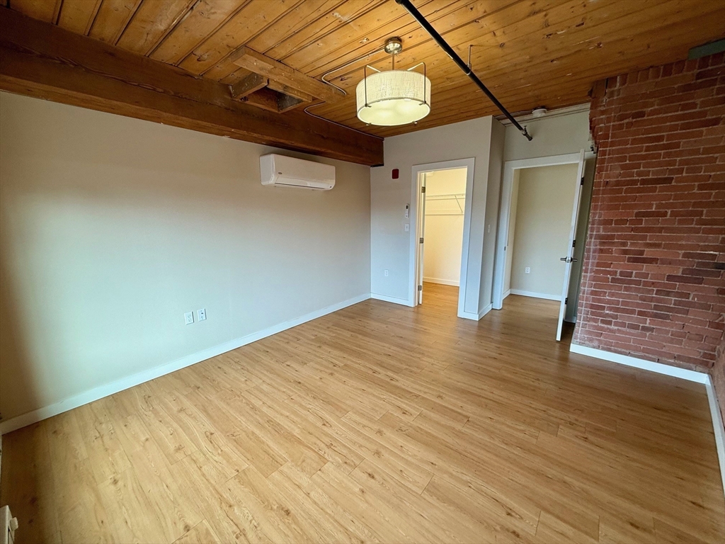 55 Sterling Street, Unit 212 Clinton, MA 01510 - Photo 8 of 35 a view of empty room with wooden floor