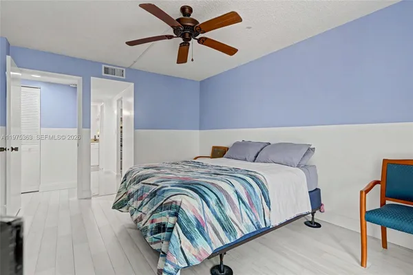 a bedroom with a bed and a ceiling fan