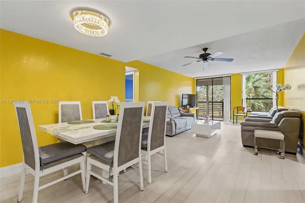 a view of a dining room with furniture and a floor to ceiling window