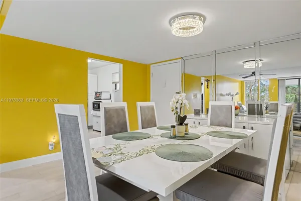 a dining room with furniture and a window