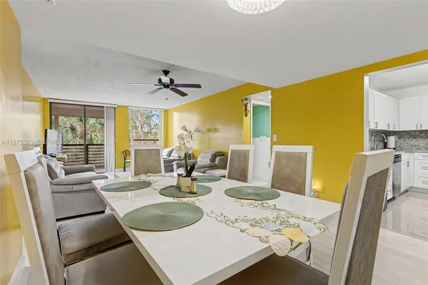 a dining room with furniture a window and wooden floor