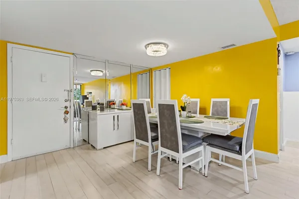 a dining room with furniture and wooden floor