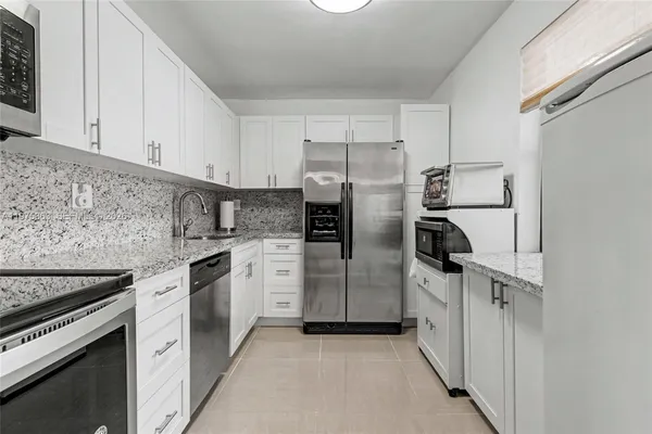 a kitchen with a stove and a refrigerator