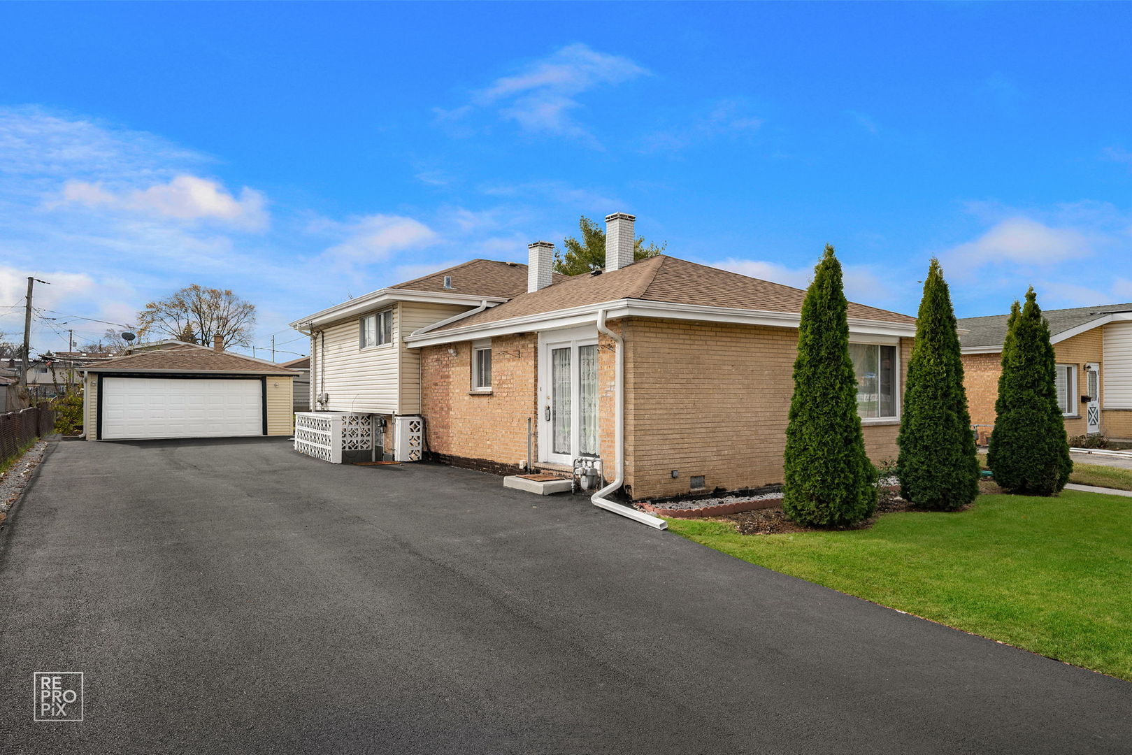 a view of a house with a yard and tree