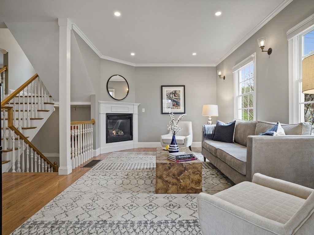 a living room with furniture a fireplace and a flat screen tv