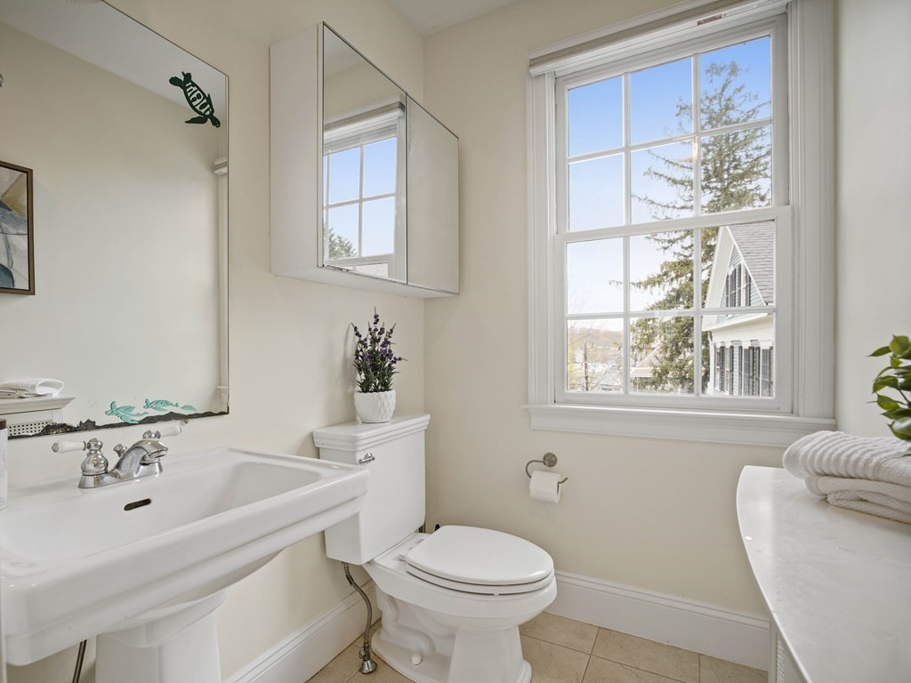 44 A Orchardhill Road, Unit A Boston, MA 02130 - Photo 17 of 37 a bathroom with a sink a toilet and a bathtub