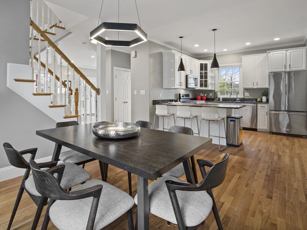 44 A Orchardhill Road, Unit A Boston, MA 02130 - Photo 5 of 37 a kitchen with stainless steel appliances a dining table chairs and a refrigerator